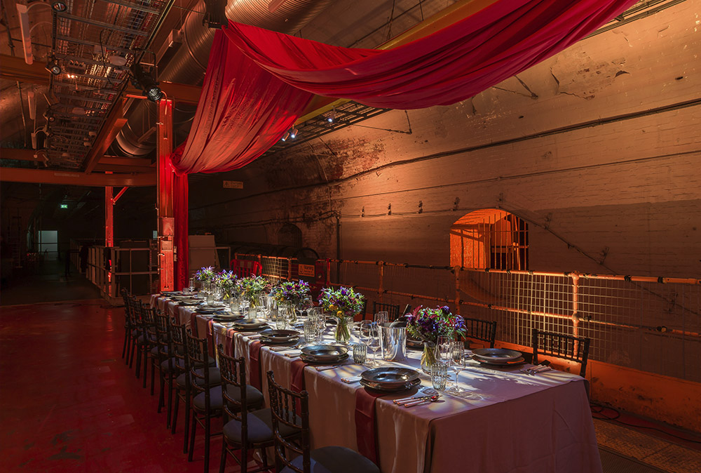 An event table set up in the Mail Rail venue space with lighting and decor.